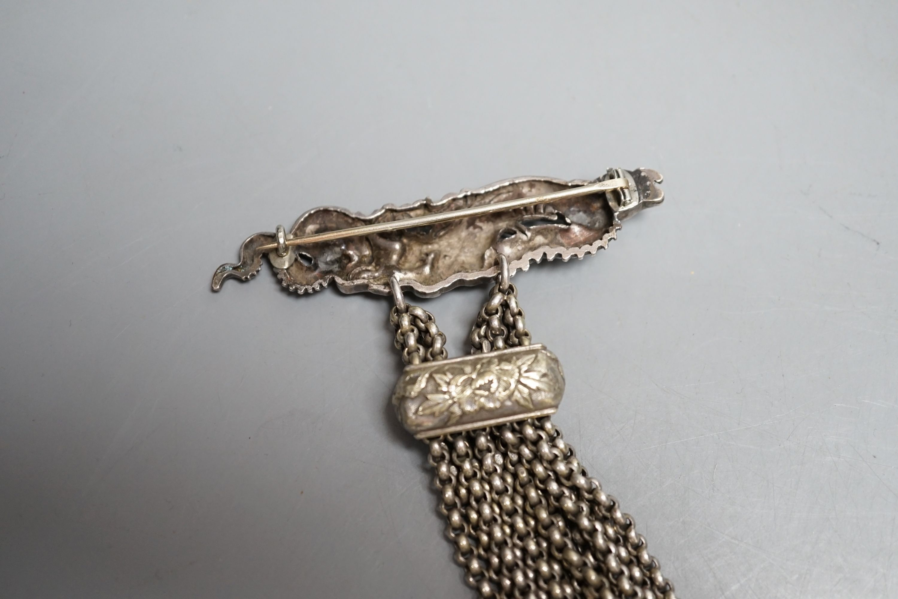 A Japanese ivory Manju netsuke with white metal and base metal suspension brooch